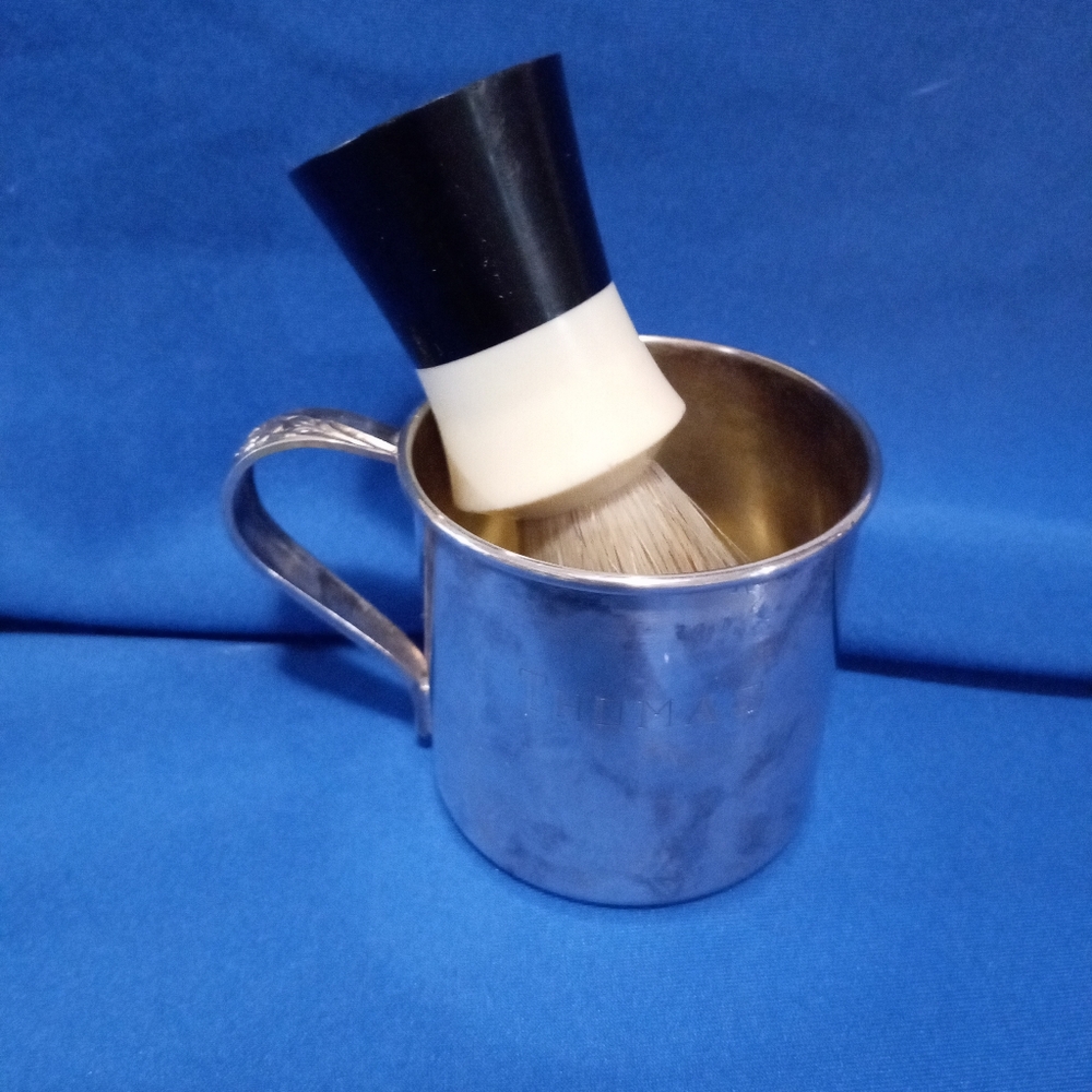 Antique sterling silver cup with a shaving brush